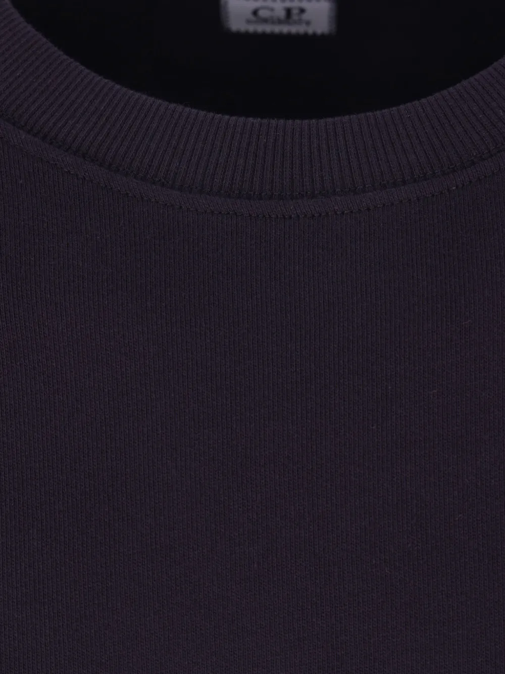 Close up of the blue sweatshirt, showing texture of the cotton fabric