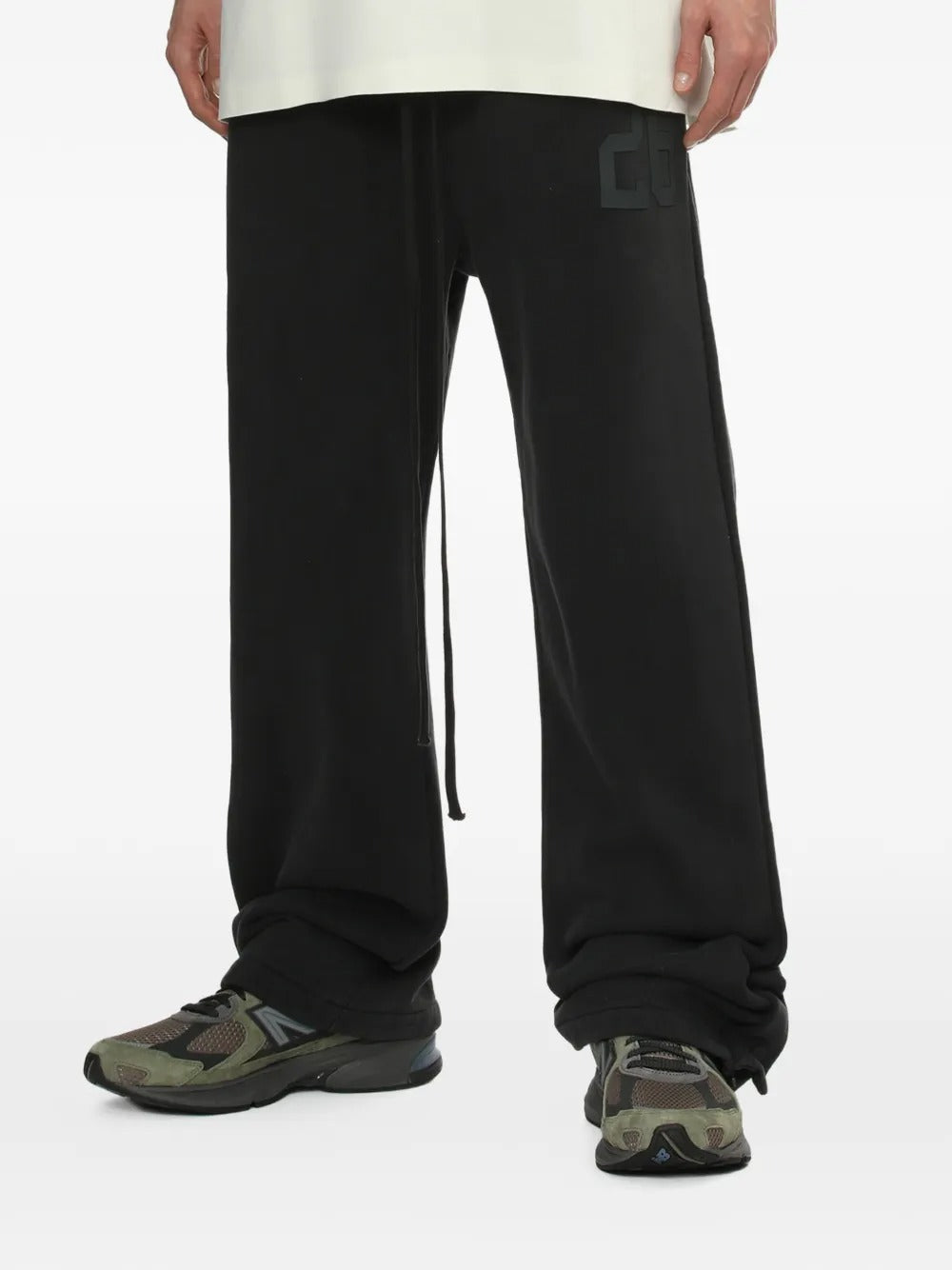 Black pants worn by a person, showing the pants' fit