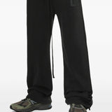 Black pants worn by a person, showing the pants' fit