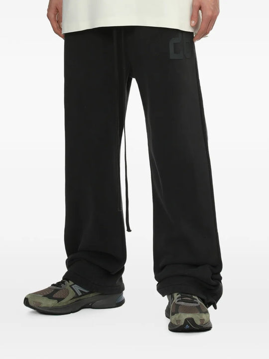Black pants worn by a person, showing the pants' fit