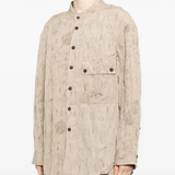 Tan shirt worn by a person, showing the shirt's fit