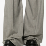 Close up of grey pant, showing texture of the virgin wool fabric