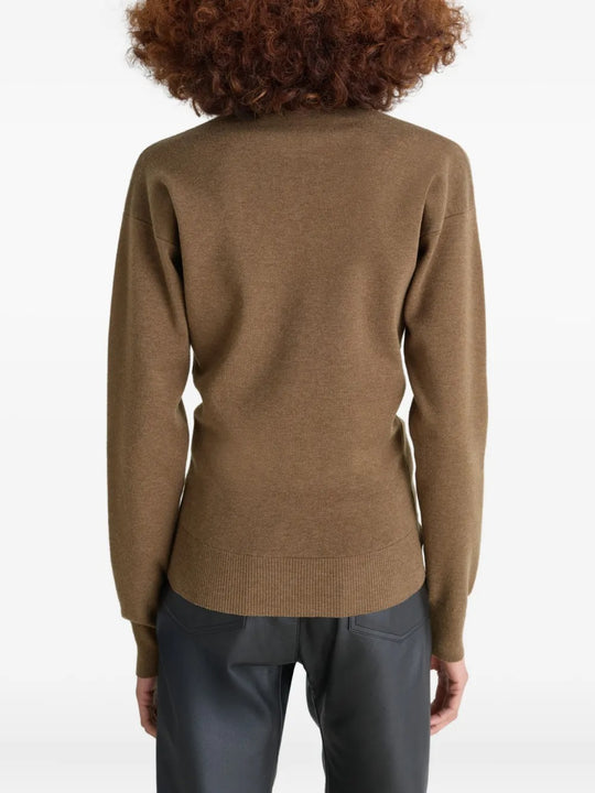 Brown knitwear worn by a person, showing the knitwear's fit