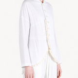 White jacket worn by a person, showing the jacket fit