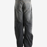 Black jeans worn by a person, showing the jeans fit