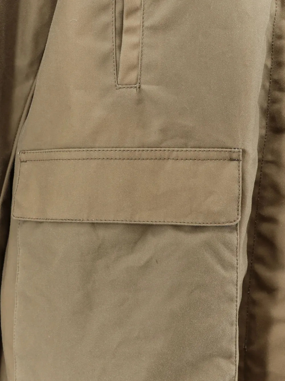 Close up of Tan jacket, showing texture of the 100% cotton fabric