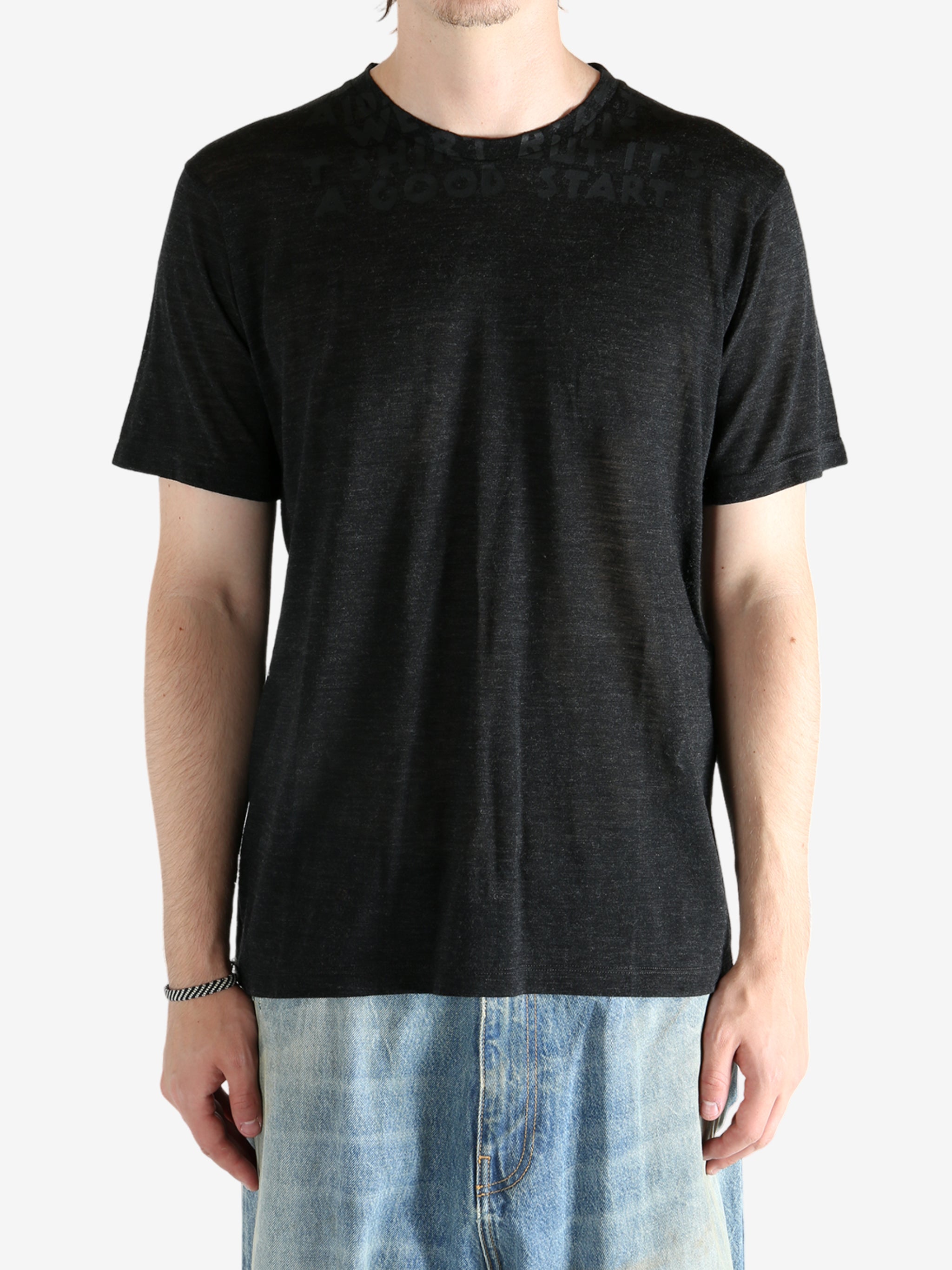 Black shirt worn by a person, showing the shirt fit