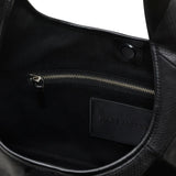 Close up of the black bag, showing texture of the leather fabric