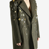 Green coat worn by a person, showing the coat fit