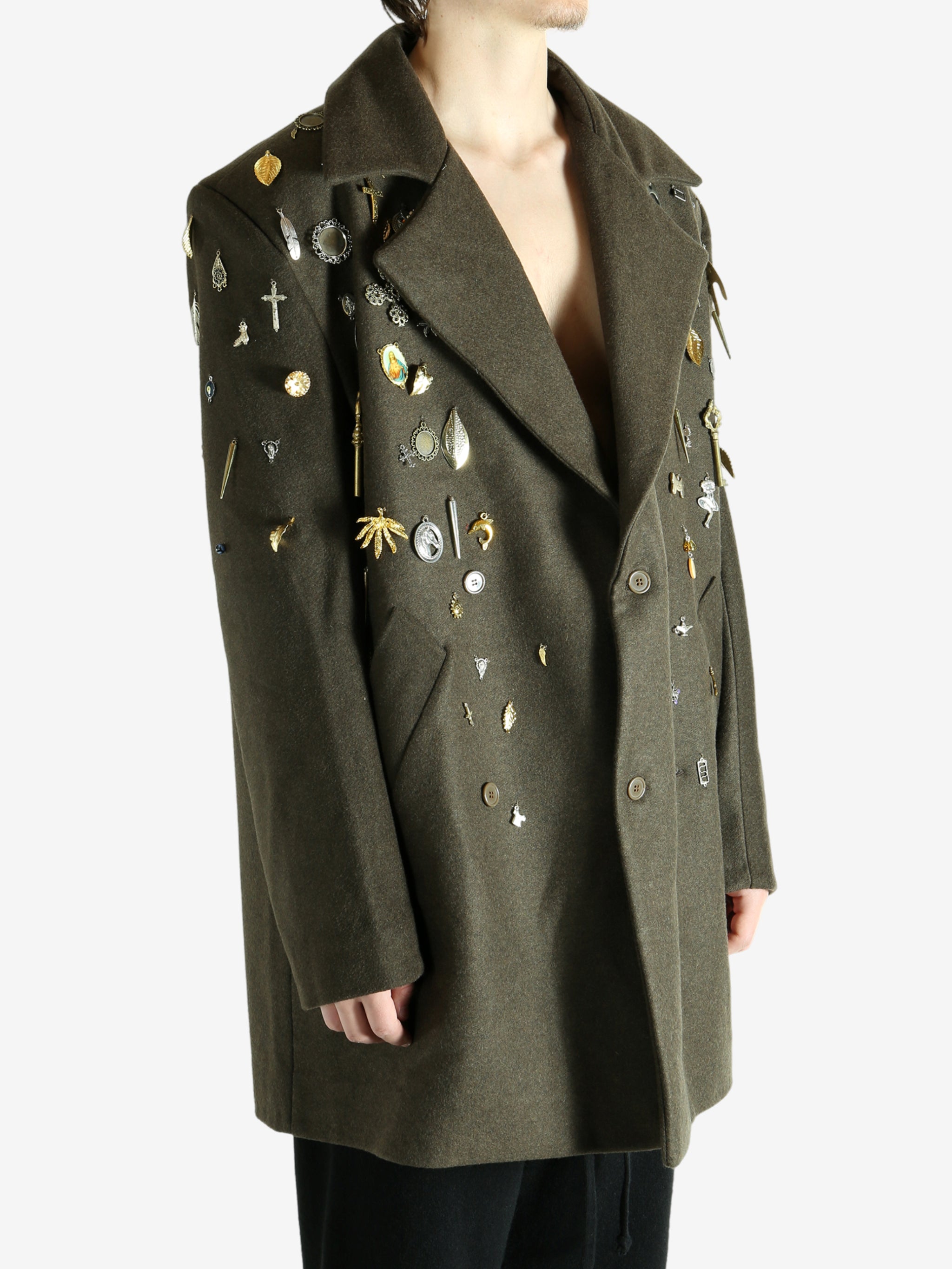 Green coat worn by a person, showing the coat fit