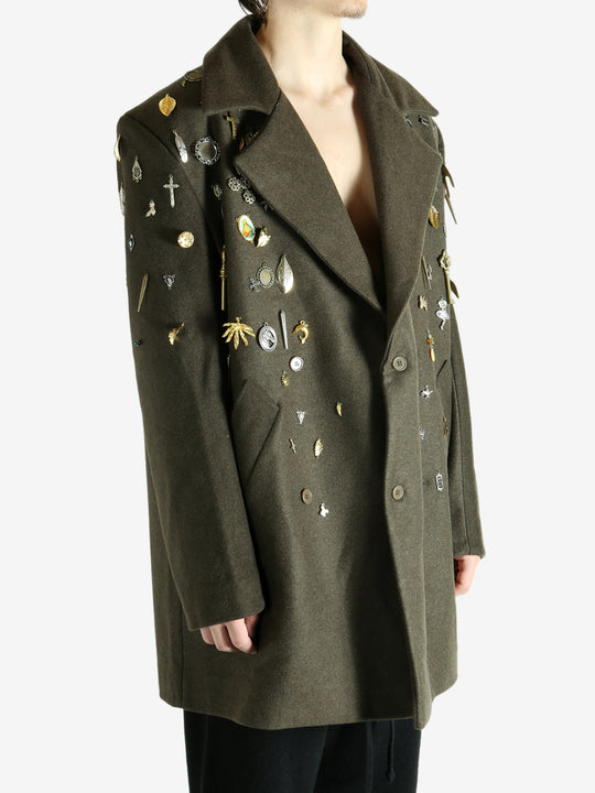 Green coat worn by a person, showing the coat fit