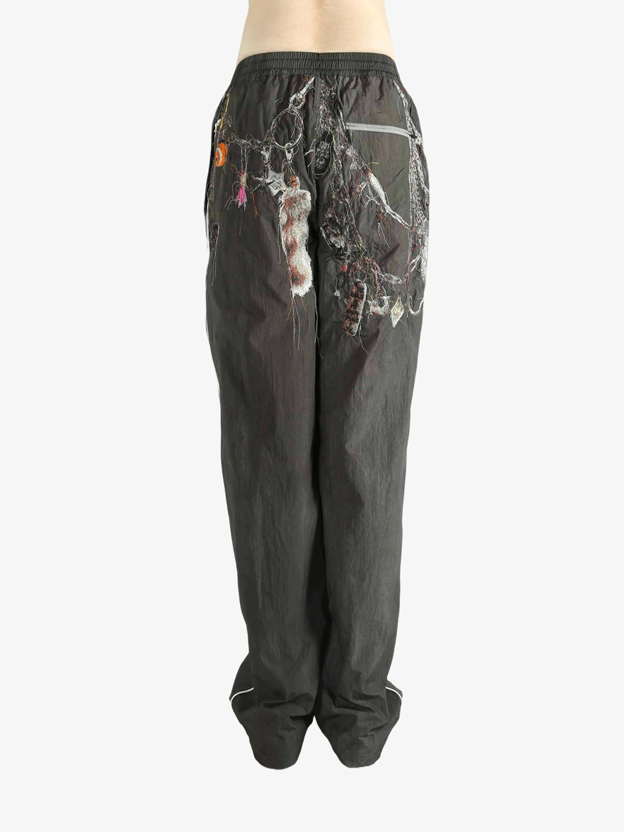 Grey pant worn by a person, showing the pant's fit