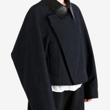 Black jacket worn by a person, showing the jacket fit
