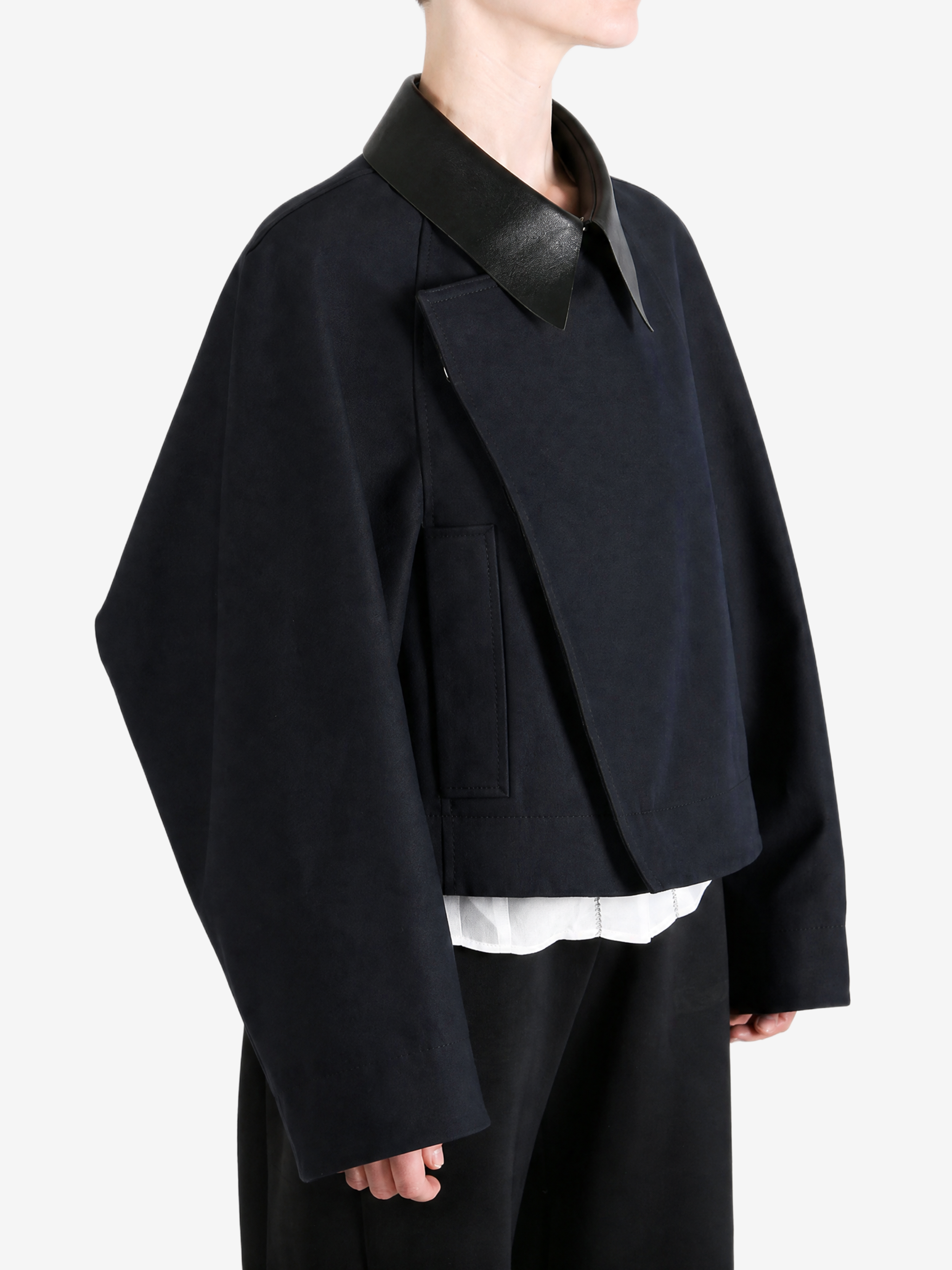 Black jacket worn by a person, showing the jacket fit