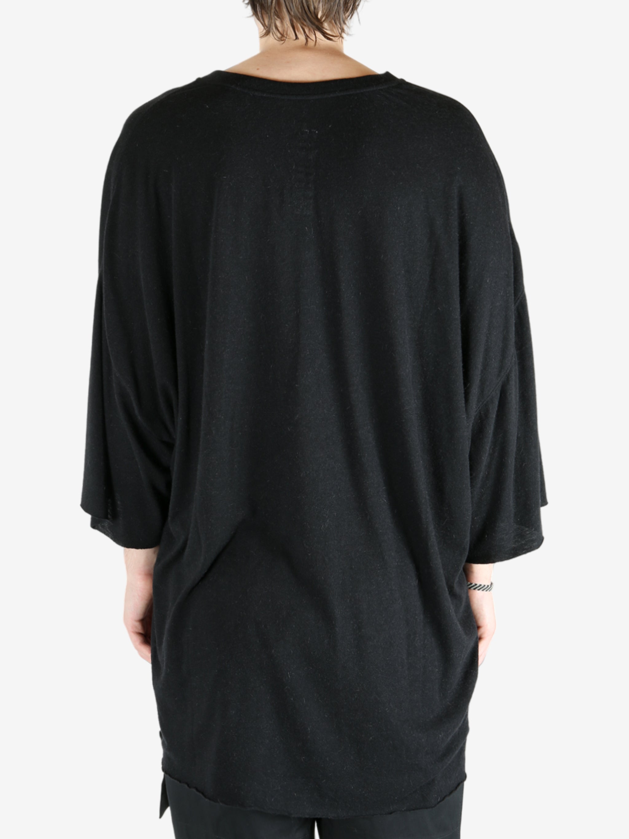 Black t-shirt worn by a person, showing the t-shirt fit