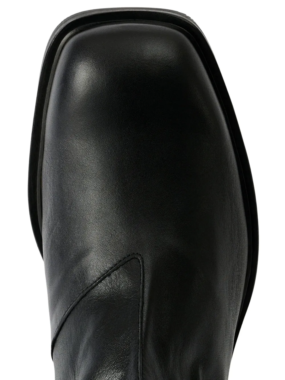 Close up of black boots, showing the detail of claf leather material