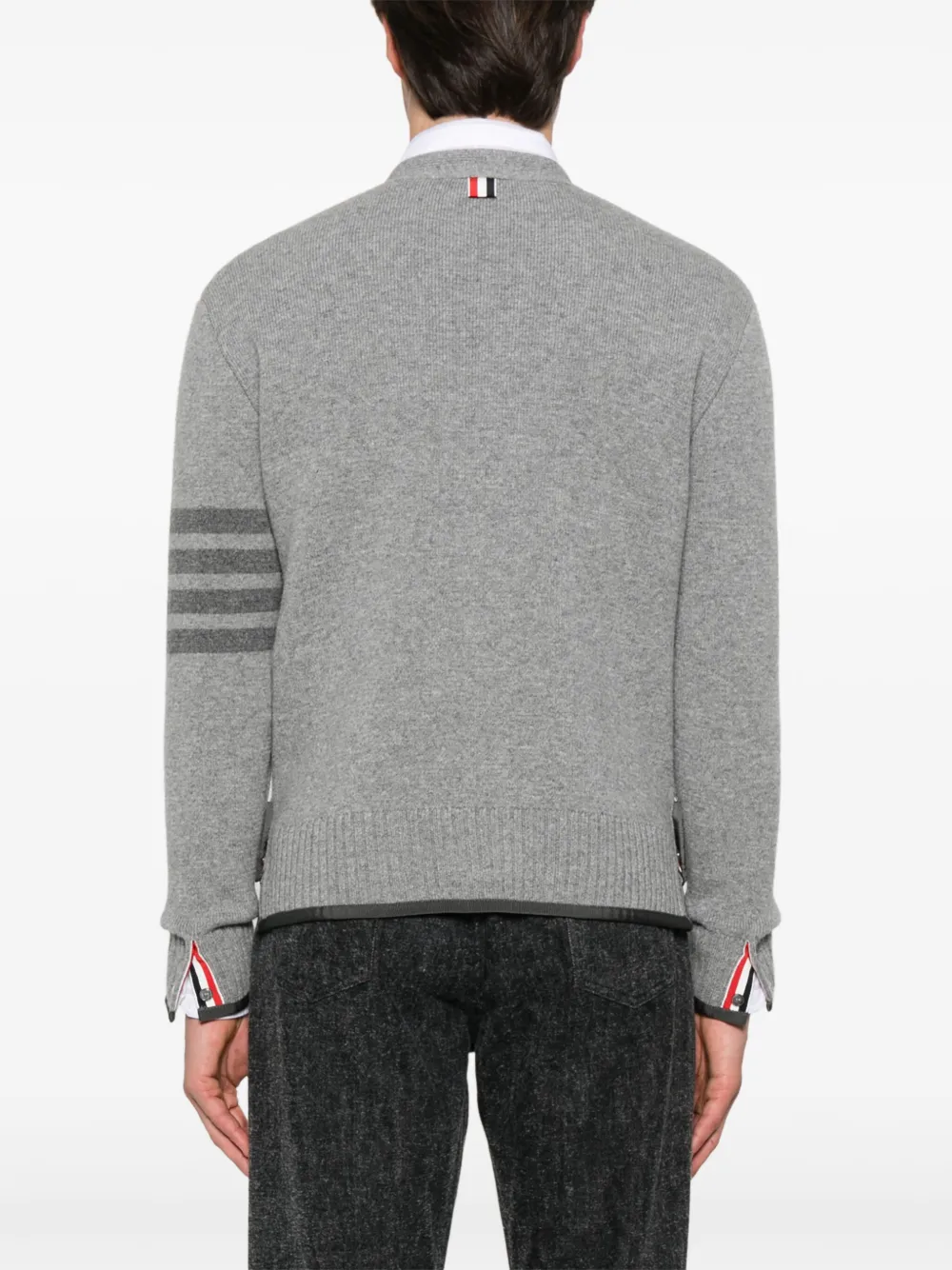 Grey knitwear worn by a person, showing the knitwear's fit