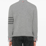 Grey knitwear worn by a person, showing the knitwear's fit