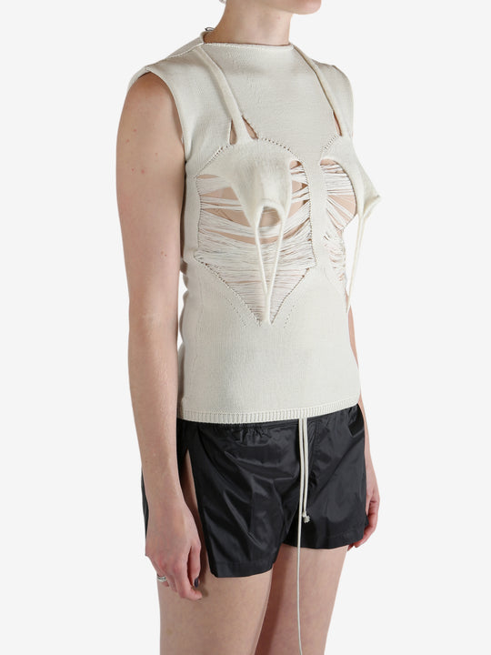 White top worn by a person, showing the top's fit