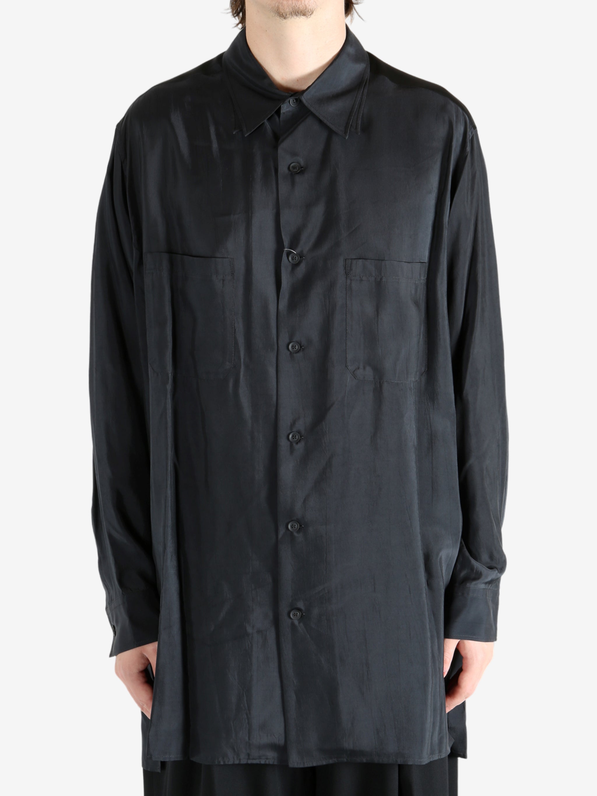 Black shirt worn by a person, showing the shirt's fit