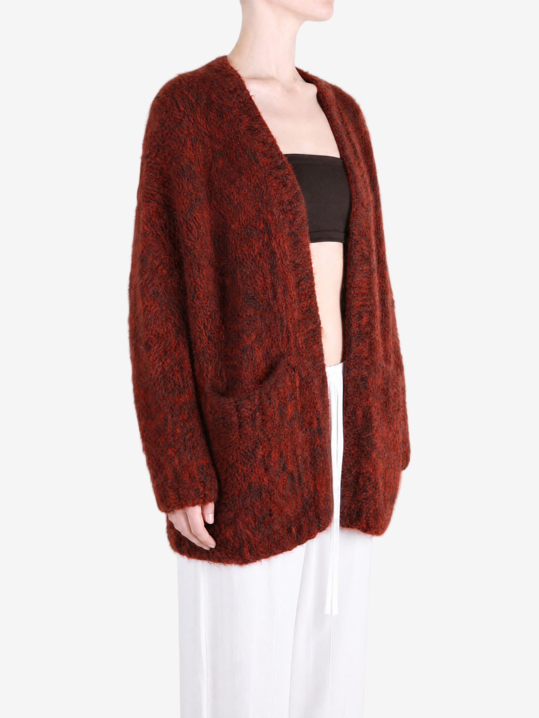 Burgundy knitwear worn by a person, showing the knitwear fit