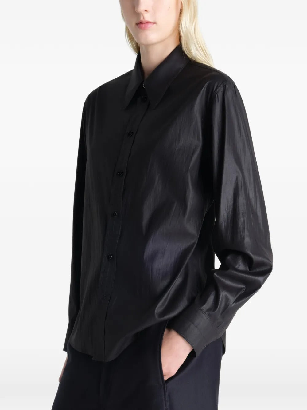 Black shirt worn by a person, showing the shirt's fit