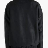 Black shirt worn by a person, showing the shirt's fit