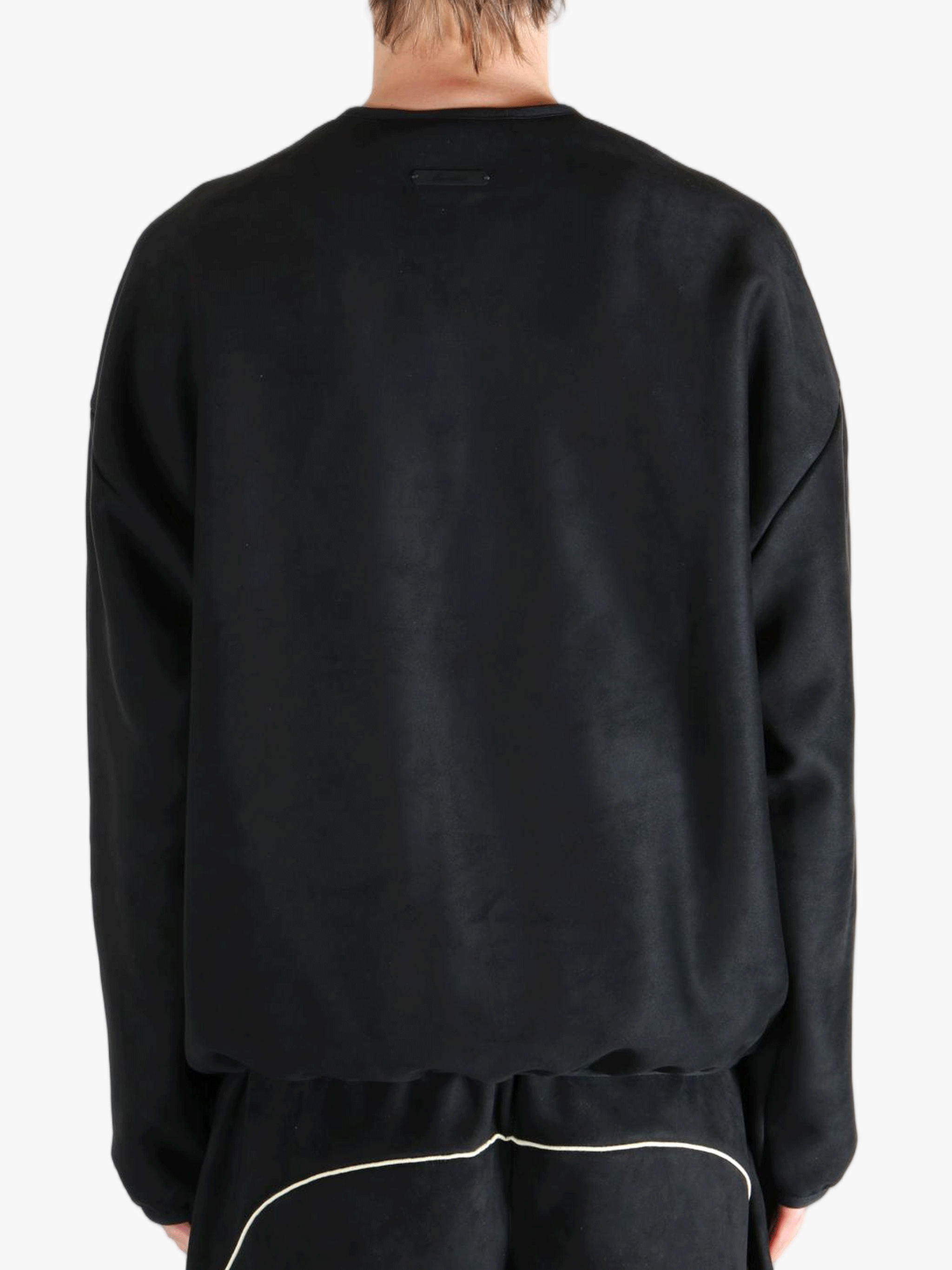 Black shirt worn by a person, showing the shirt's fit