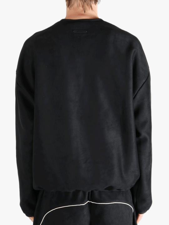Black shirt worn by a person, showing the shirt's fit