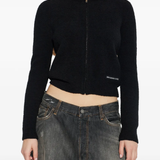 black hoodie worn by a person, showing the hoodie fit