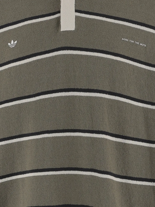 Close up of green t-shirts, showing texture of the cotton fabric