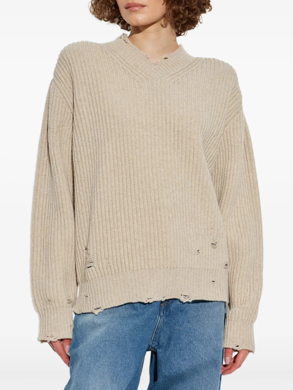 Tan sweater worn by a person, showing the sweater's fit