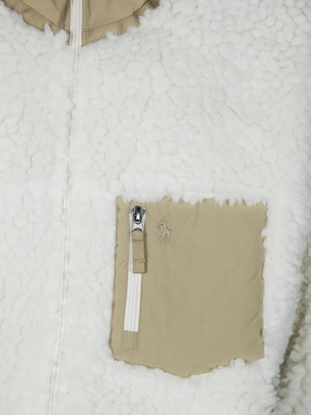 Close up of Tan jacket, showing texture of the 100% polyester fabric