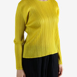 Yellow top worn by a person, showing the top fit
