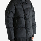 Black coat worn by a person, showing the coat's fit