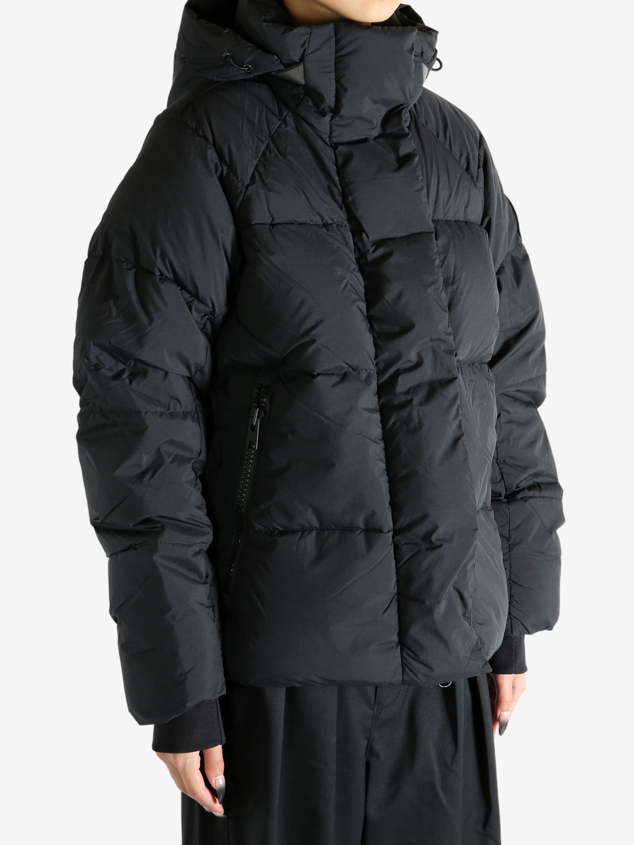 Black coat worn by a person, showing the coat's fit