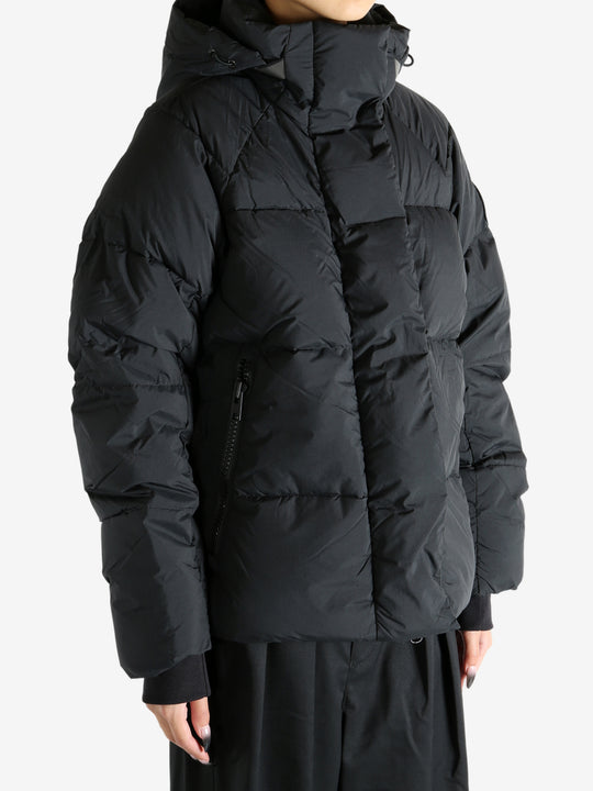 Black coat worn by a person, showing the coat's fit