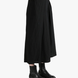 Black skirts worn by a person, showing the skirts fit