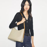 White bag worn by a person, showing the bag's  fit