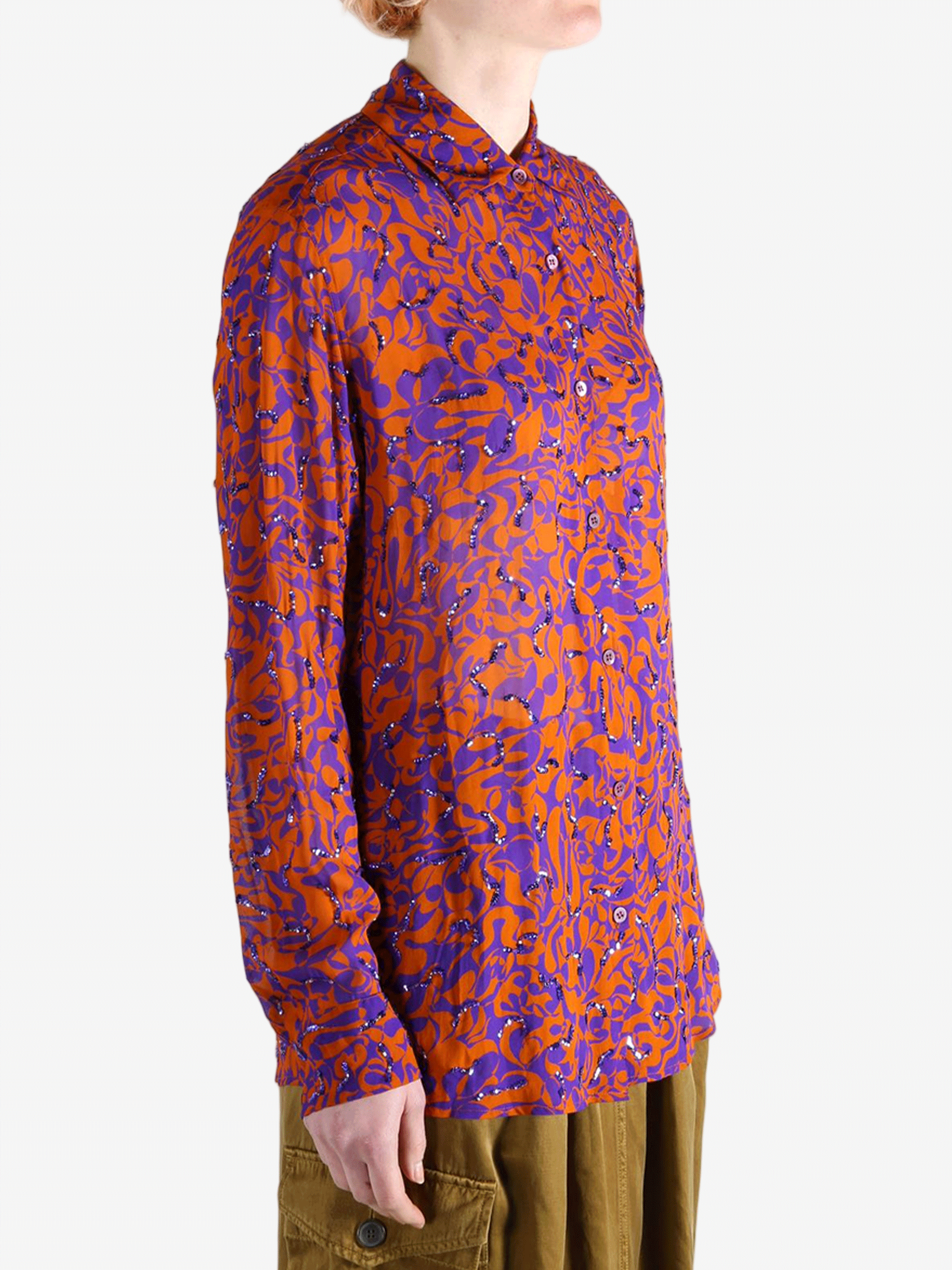 Red top worn by a person, showing the top fit