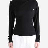 Black top worn by a person, showing the top fit