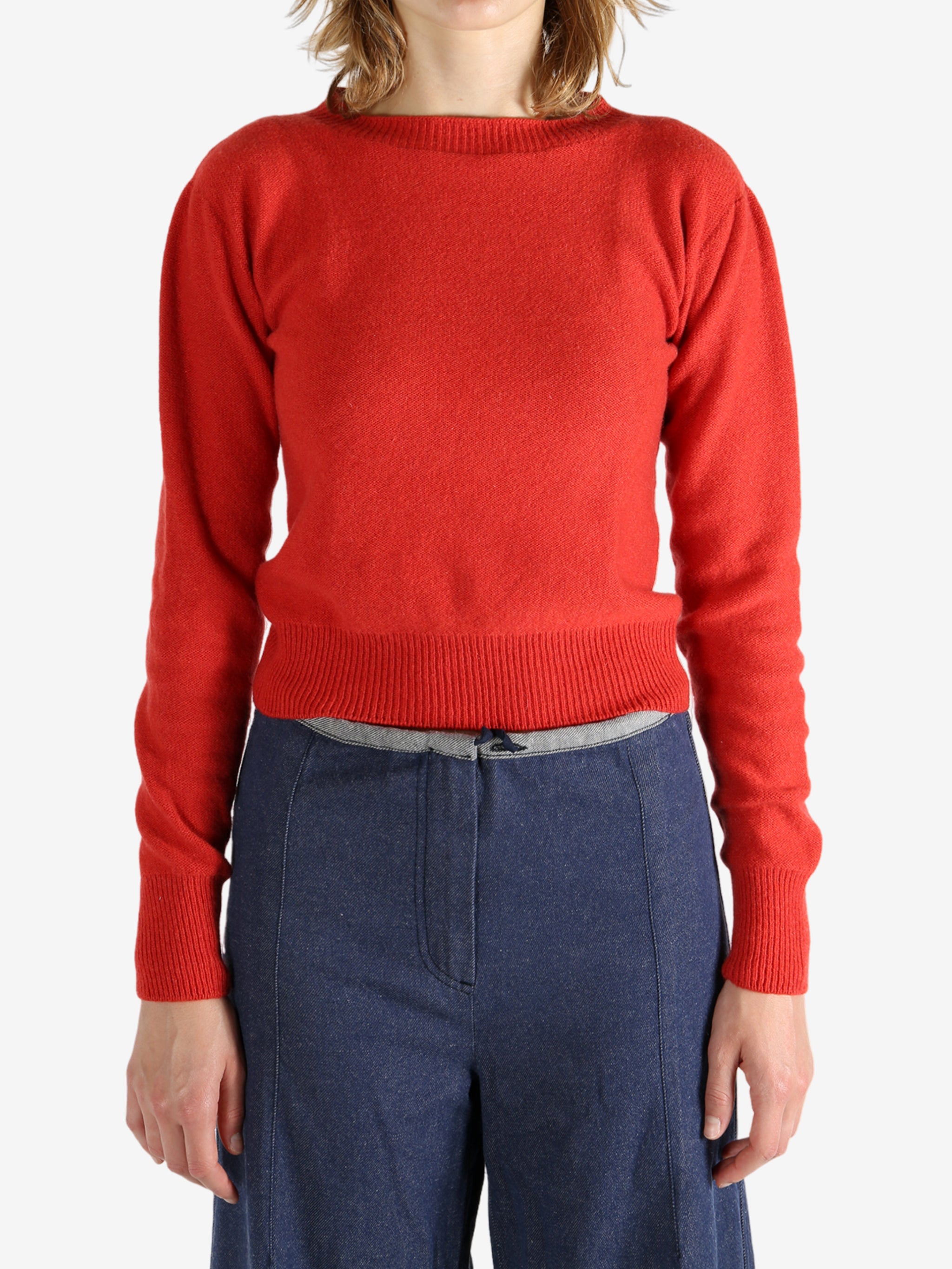 Red sweater worn by a person, showing the sweater fit