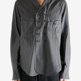 Grey shirt worn by a person. showing the shirt's fit