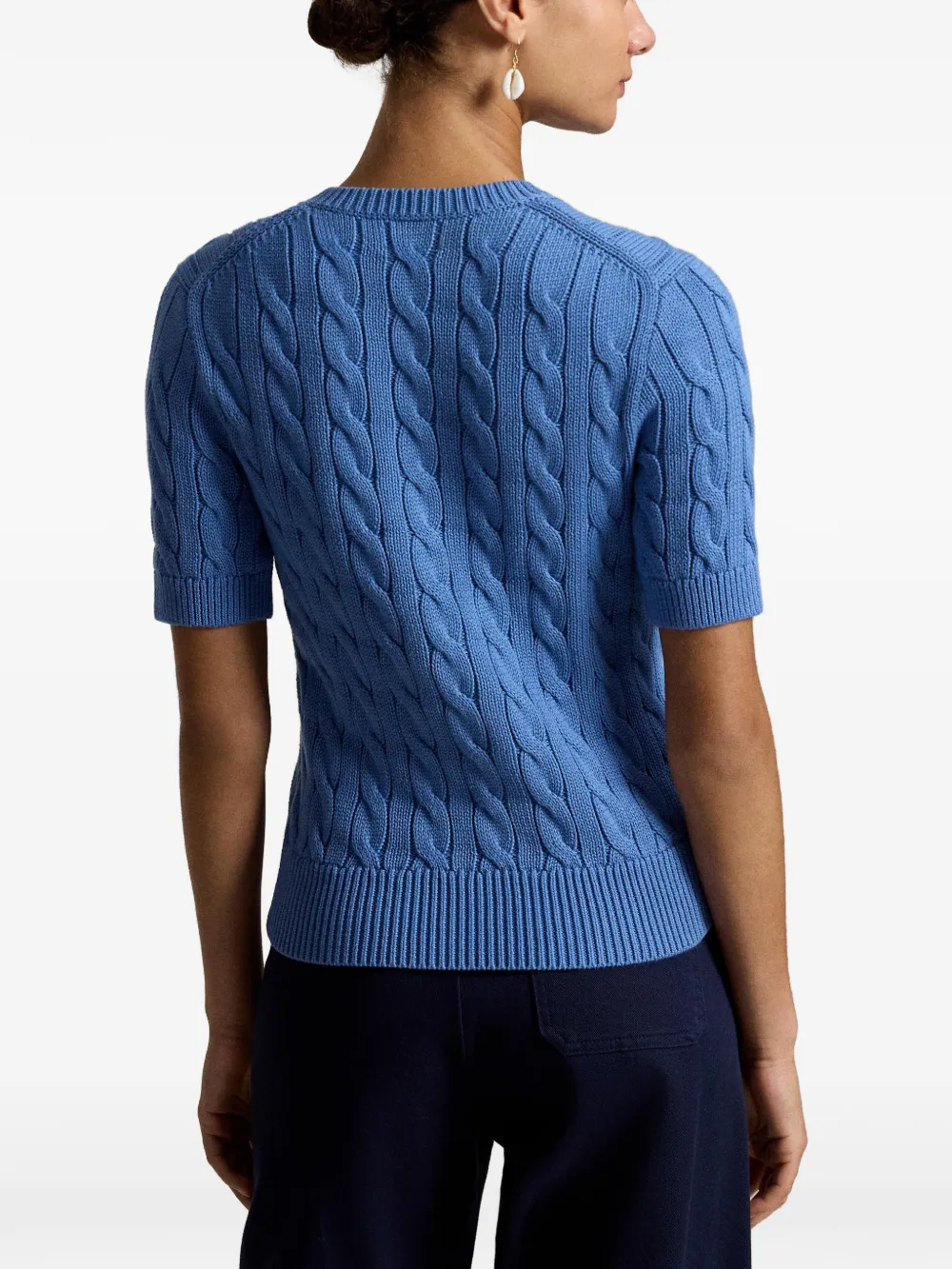 Blue knitwear worn by a person, showing the knitwear fit