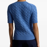 Blue knitwear worn by a person, showing the knitwear fit