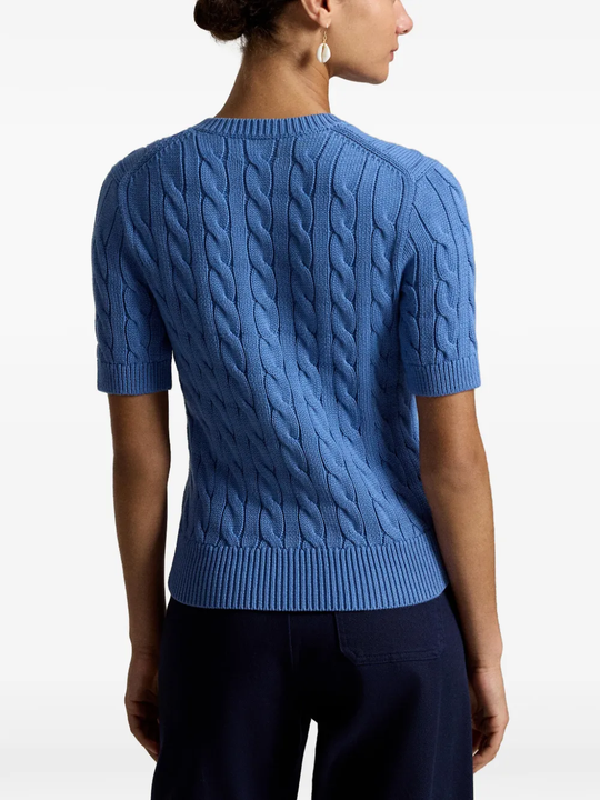 Blue knitwear worn by a person, showing the knitwear fit