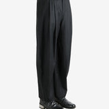 Black pants worn by a person, showing the pants fit