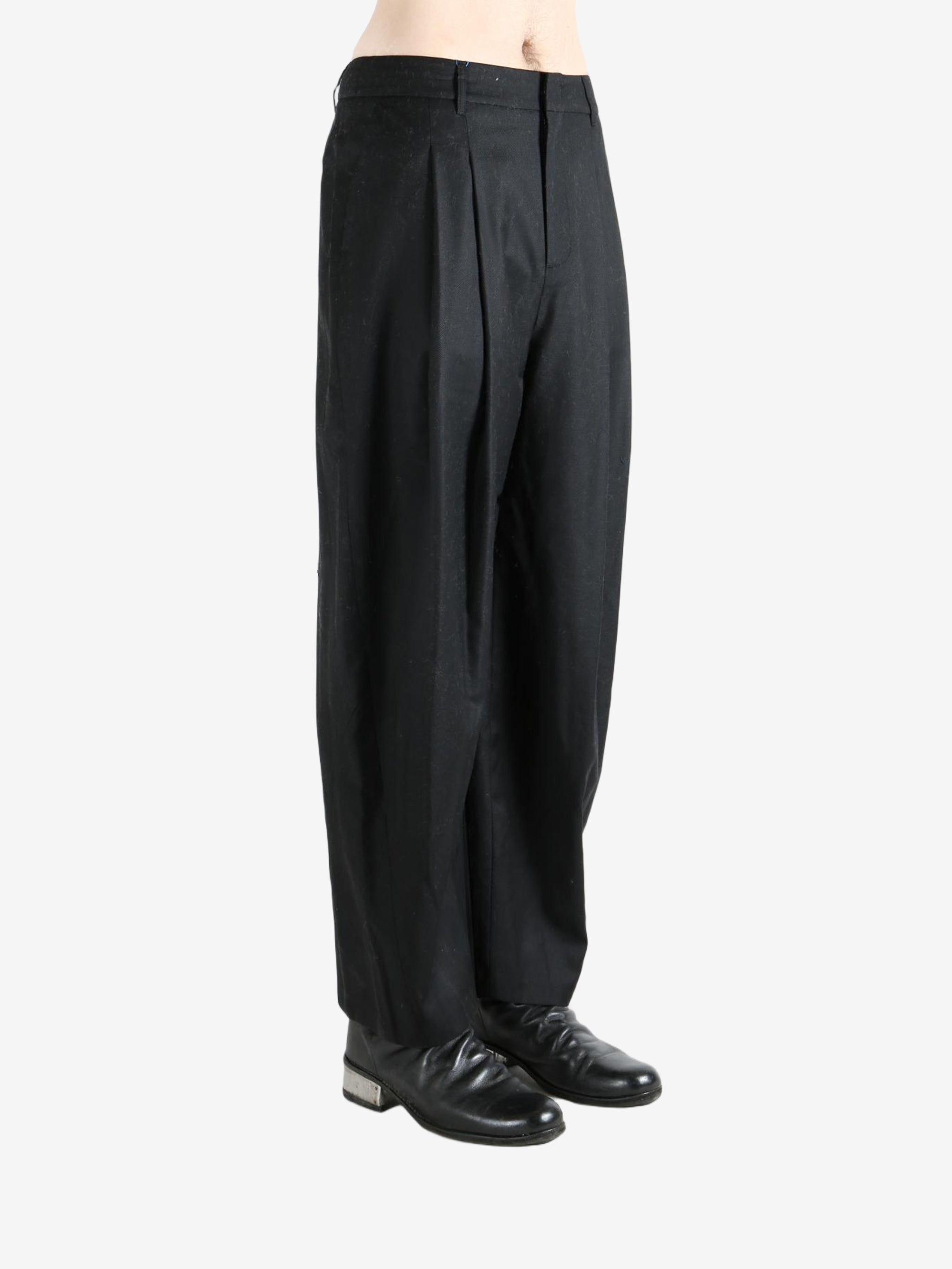 Black pants worn by a person, showing the pants fit