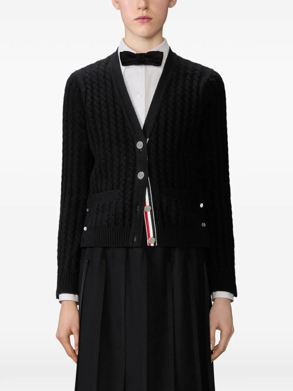 Black cardigan worn by a person, showing the cardigan's  fit