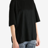 Black t-shirt worn by a person, showing the shirt's fit